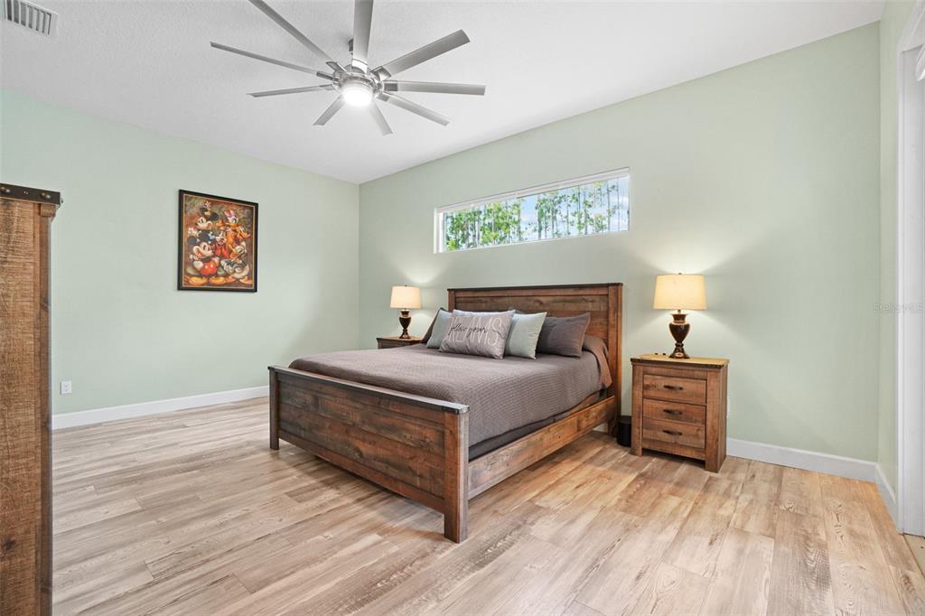 3230 Pheasant Trail Mims, FL 32754 - Photo 20 of 71 a bedroom with a bed and wooden floor