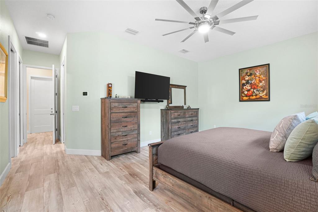 3230 Pheasant Trail Mims, FL 32754 - Photo 21 of 71 a bedroom with a bed and a flat tv screen on dresser