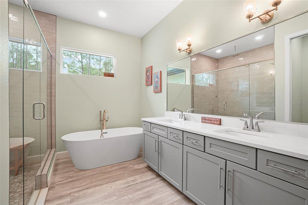 3230 Pheasant Trail Mims, FL 32754 - Photo 23 of 71 a bathroom with a double vanity sink mirror and bathtub