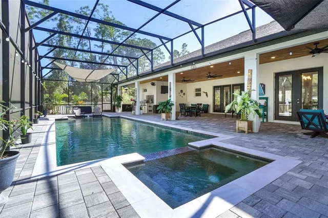 an aerial view of a house with a swimming pool yard and outdoor seating