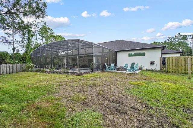 a backyard of a house with a yard and outdoor seating