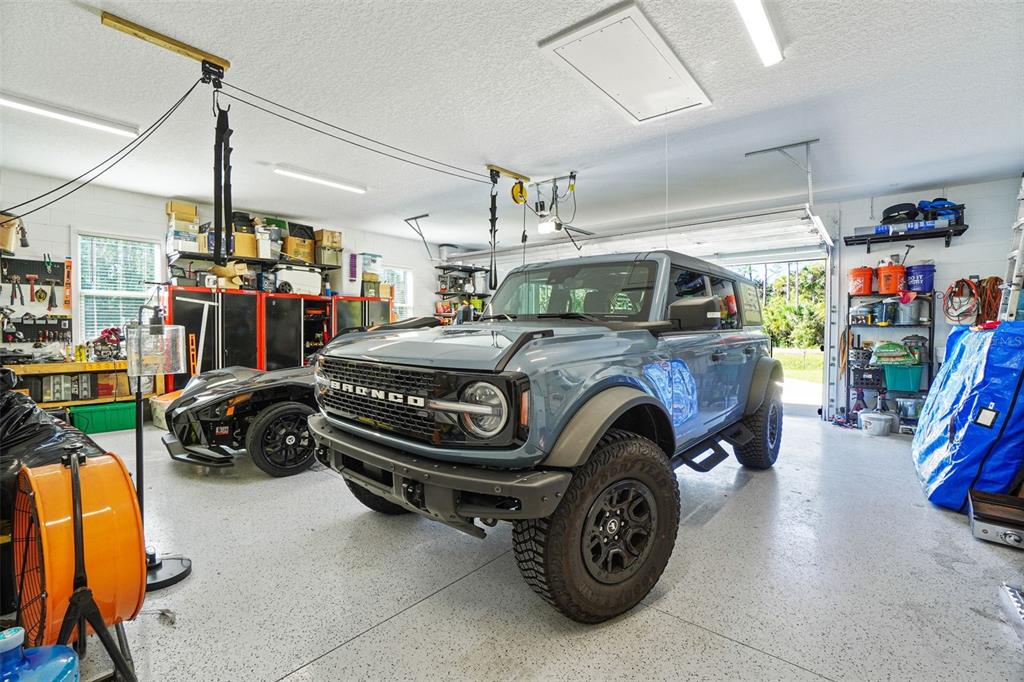 3230 Pheasant Trail Mims, FL 32754 - Photo 54 of 71 a view of parking garage with cars and other equipment