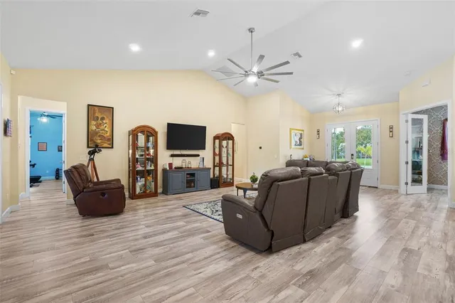 a living room with furniture and a wooden floor