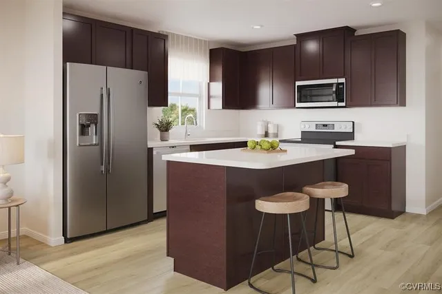 a kitchen with stainless steel appliances granite countertop a refrigerator and a stove top oven