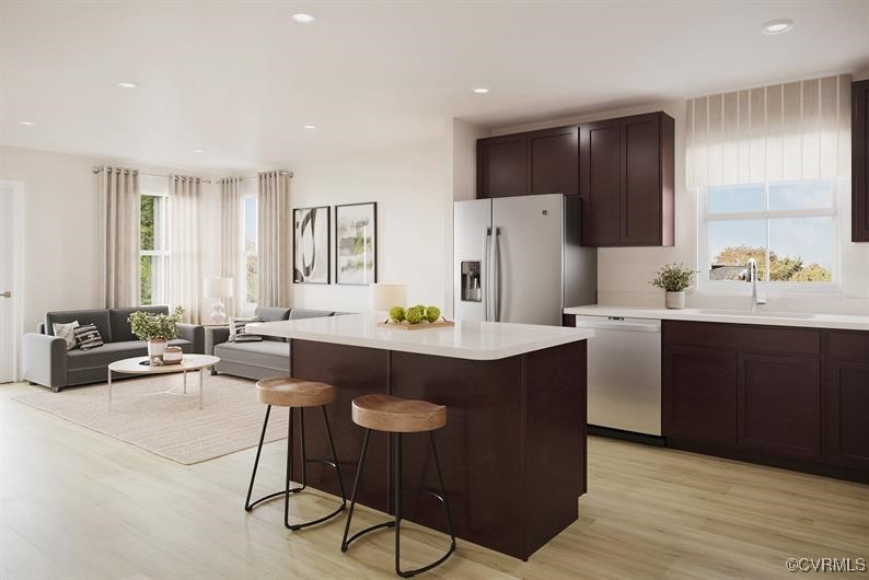 2119 Destination Drive, Unit A Sandston, VA 23150 - Photo 3 of 9 a kitchen with stainless steel appliances kitchen island granite countertop a sink a stove a refrigerator and white cabinets with wooden floor