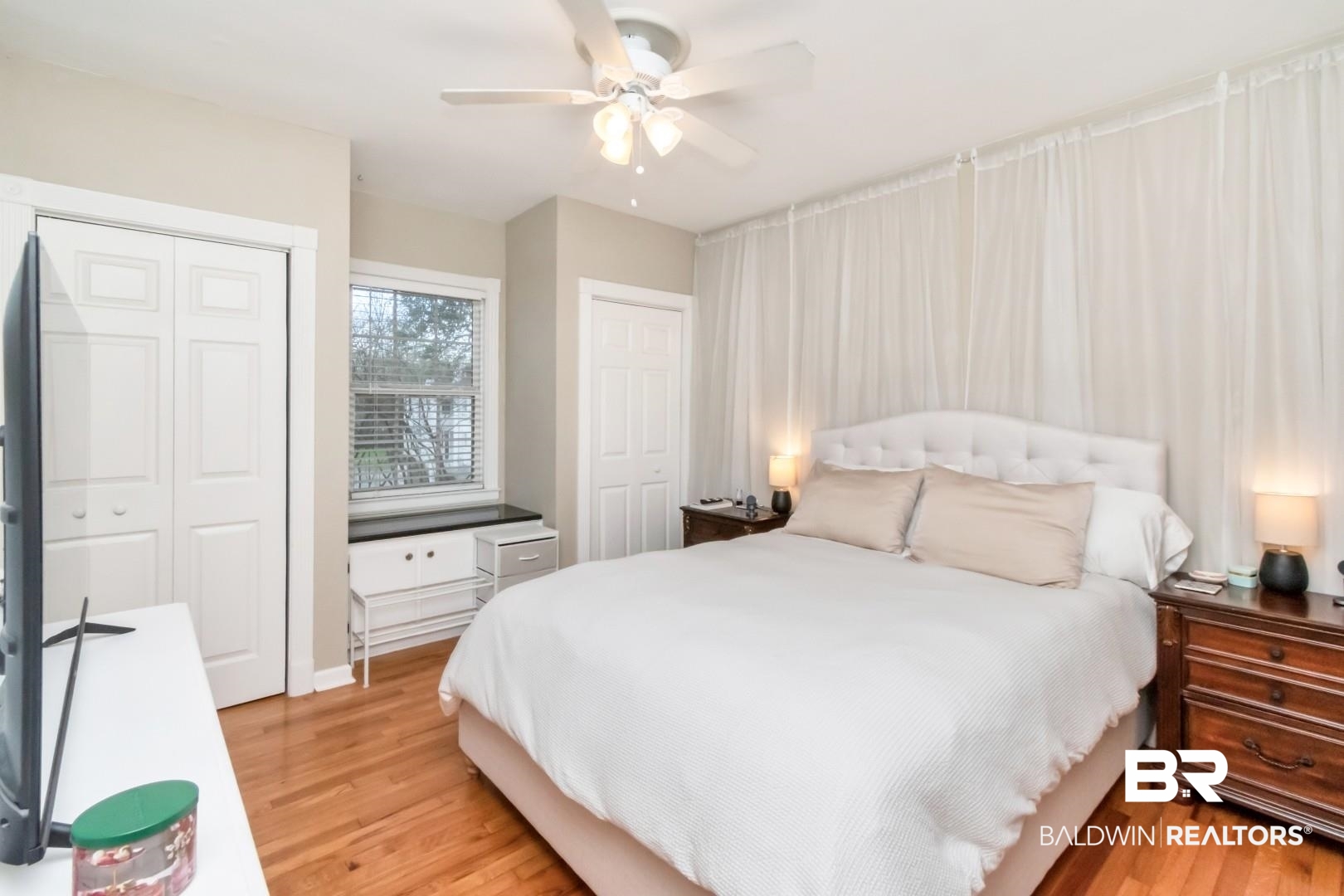 214 Upham Street, Unit 17C Mobile, AL 36607 - Photo 25 of 32 Bedroom with light wood-style flooring, a ceiling fan, and two closets