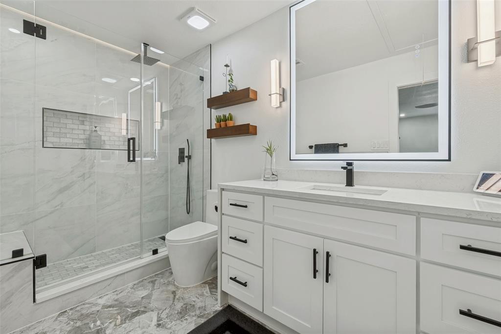 10635 Stone Canyon Road, Unit 19 Dallas, TX 75230 - Photo 16 of 25 a bathroom with a sink toilet and shower