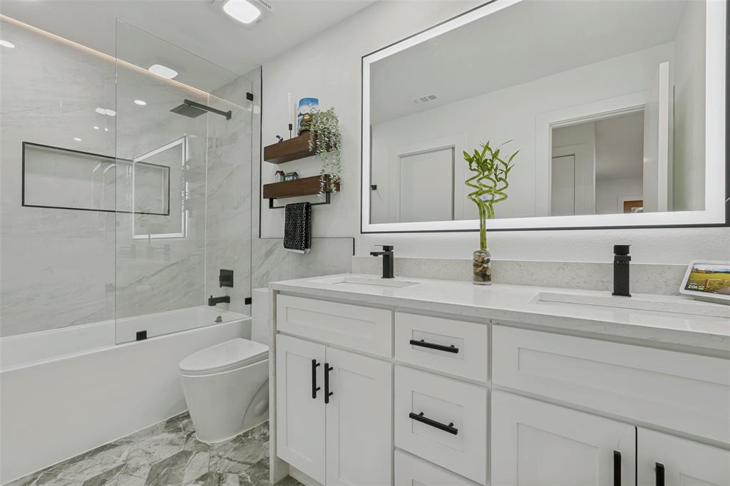 10635 Stone Canyon Road, Unit 19 Dallas, TX 75230 - Photo 17 of 25 a bathroom with a sink a toilet and shower
