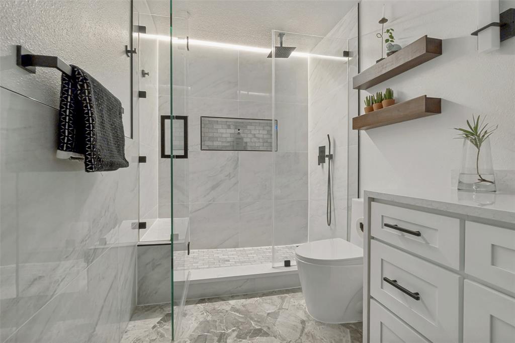10635 Stone Canyon Road, Unit 19 Dallas, TX 75230 - Photo 21 of 25 a bathroom with a sink a toilet and shower