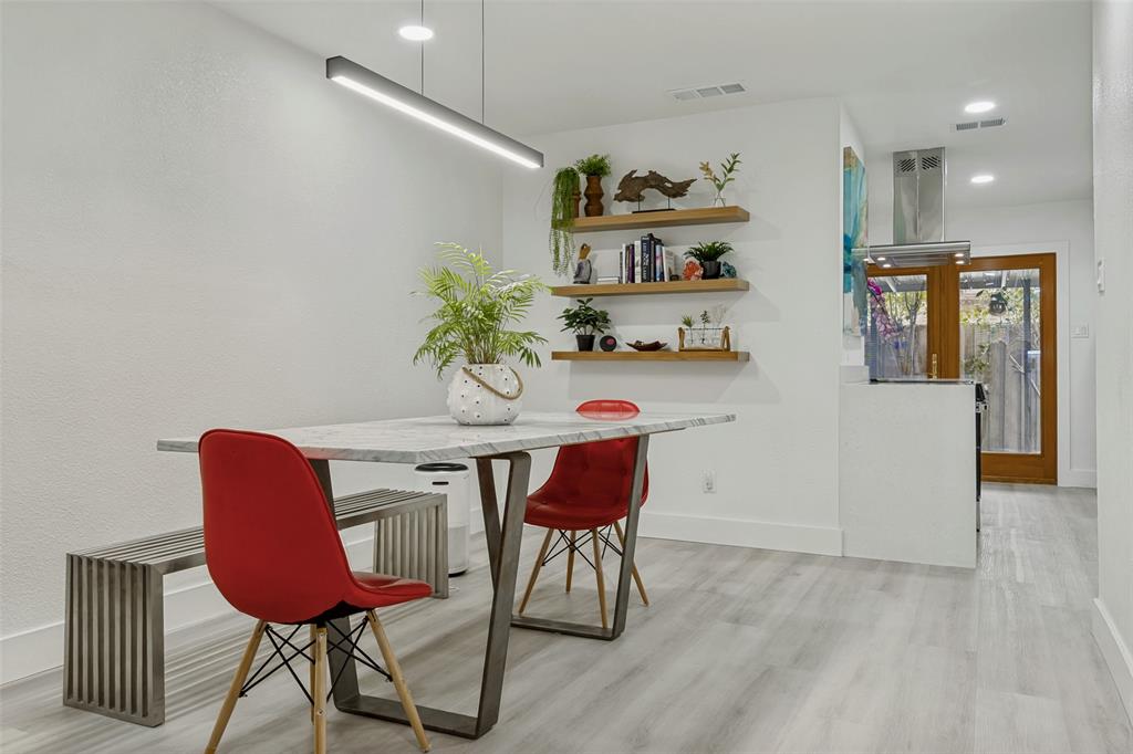 10635 Stone Canyon Road, Unit 19 Dallas, TX 75230 - Photo 6 of 25 a view of a dining room with furniture and wooden floor