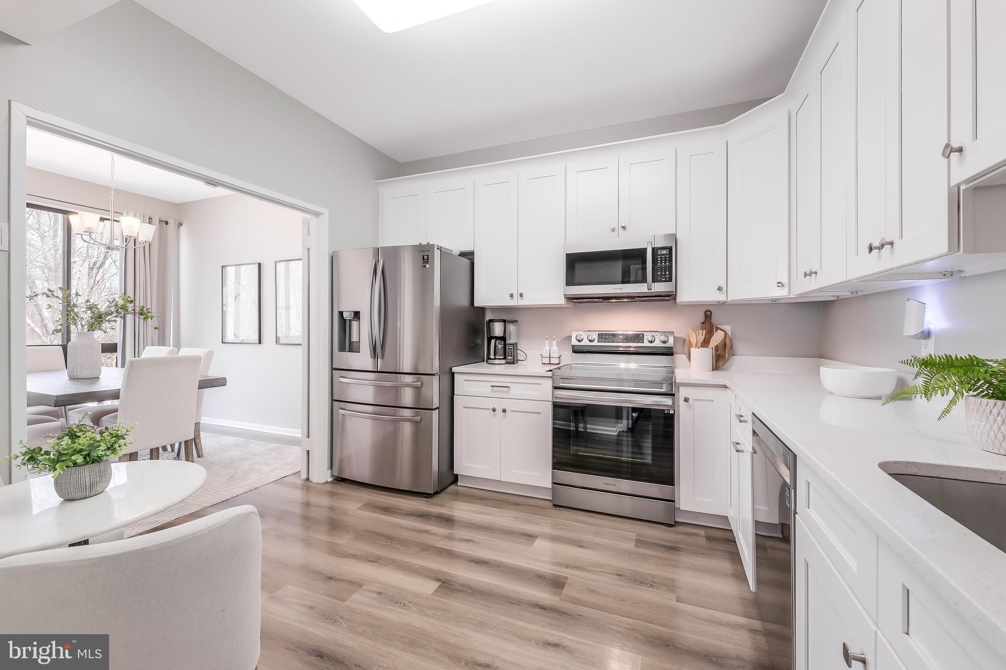 a kitchen with a refrigerator and a stove top oven