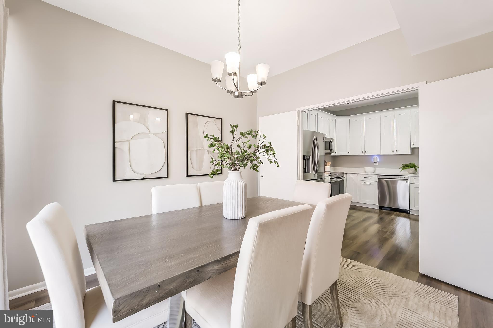 11564 Rolling Green Court, Unit 12/301B Reston, VA 20191 - Photo 12 of 31 a dining room with furniture and chandelier