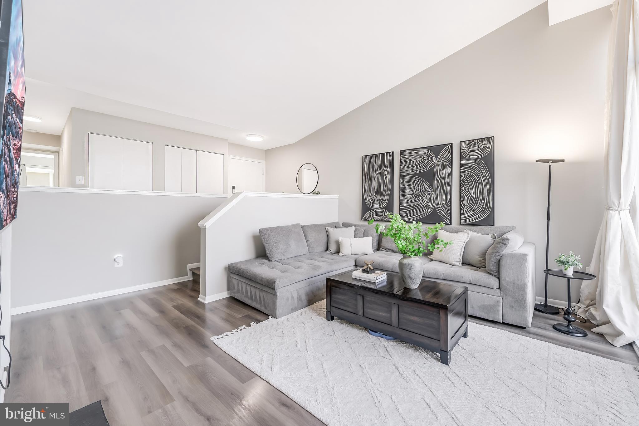 11564 Rolling Green Court, Unit 12/301B Reston, VA 20191 - Photo 13 of 31 a living room with furniture and a large window