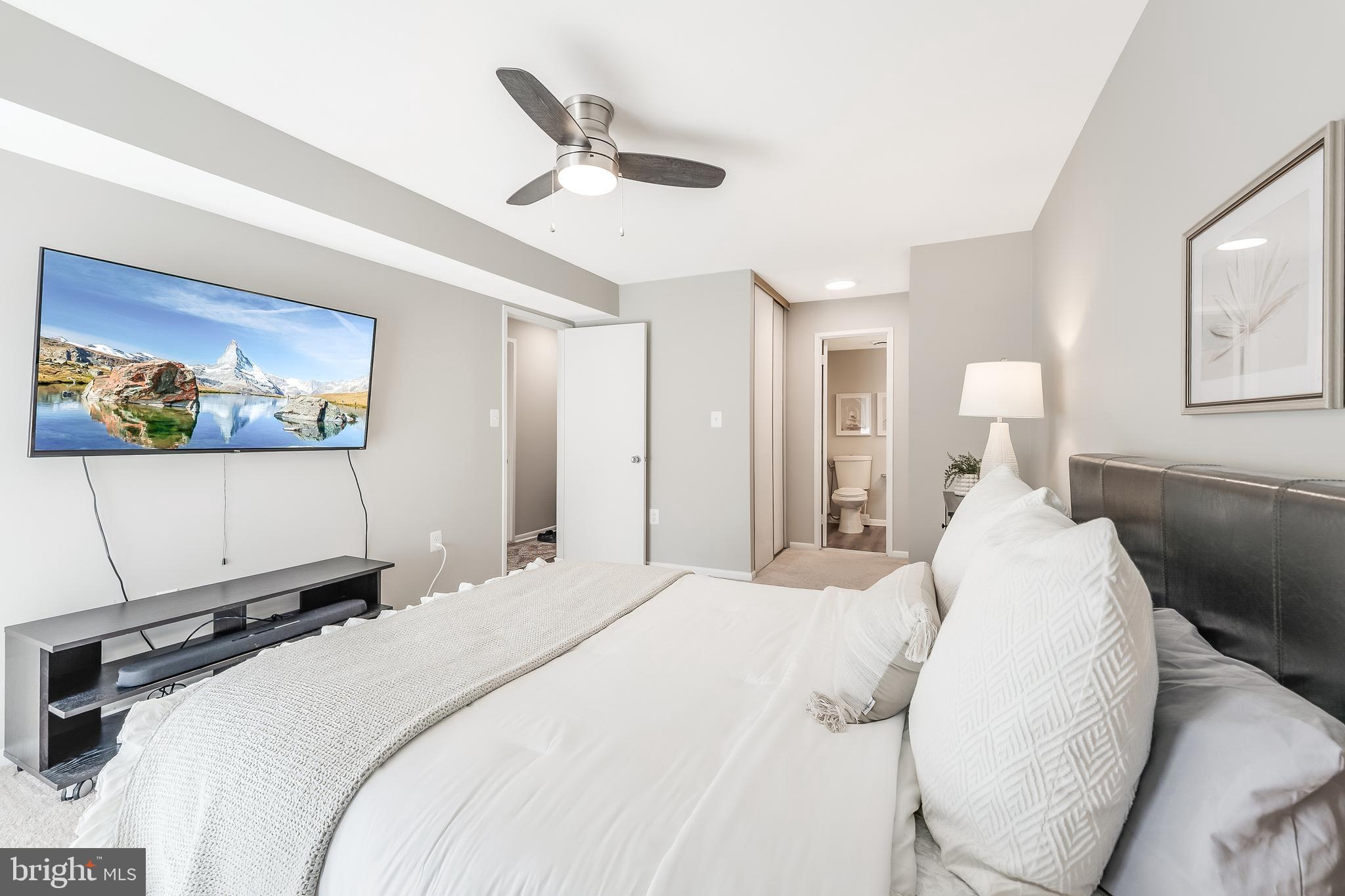 11564 Rolling Green Court, Unit 12/301B Reston, VA 20191 - Photo 18 of 31 a bedroom with a bed and a painting on the wall
