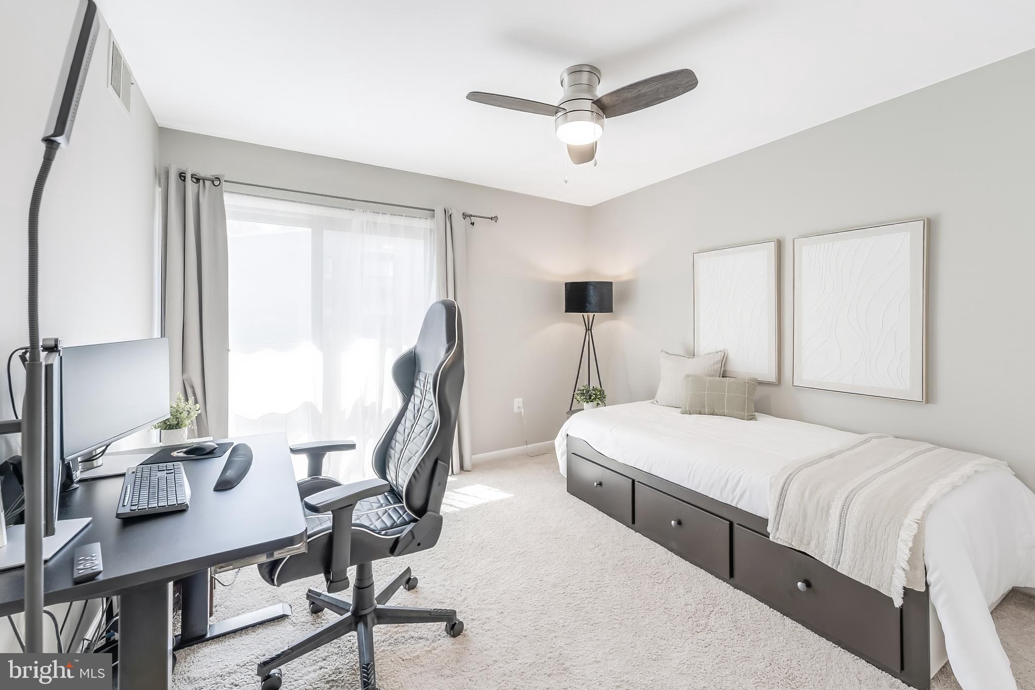 11564 Rolling Green Court, Unit 12/301B Reston, VA 20191 - Photo 23 of 31 a bedroom with two beds a chandelier and a window