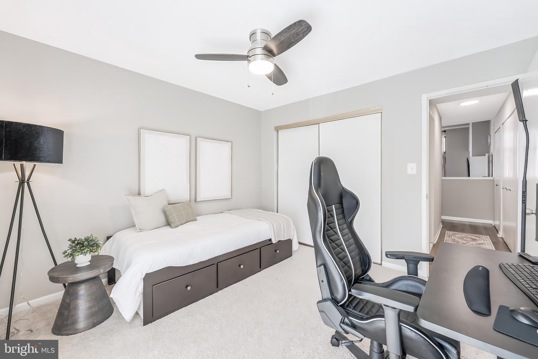 11564 Rolling Green Court, Unit 12/301B Reston, VA 20191 - Photo 24 of 31 a bedroom with a bed and a chandelier