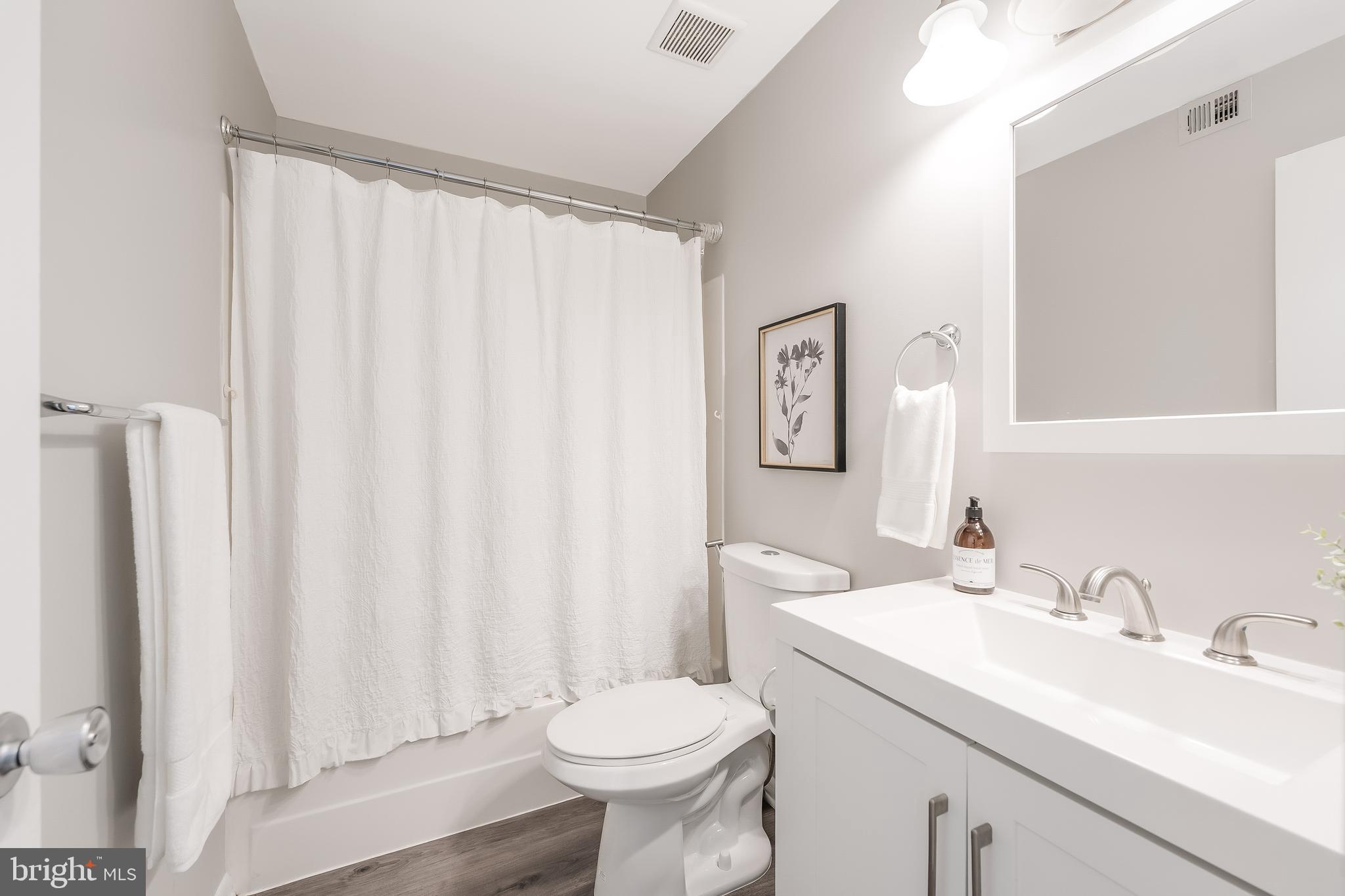 11564 Rolling Green Court, Unit 12/301B Reston, VA 20191 - Photo 25 of 31 a bathroom with a sink toilet and shower