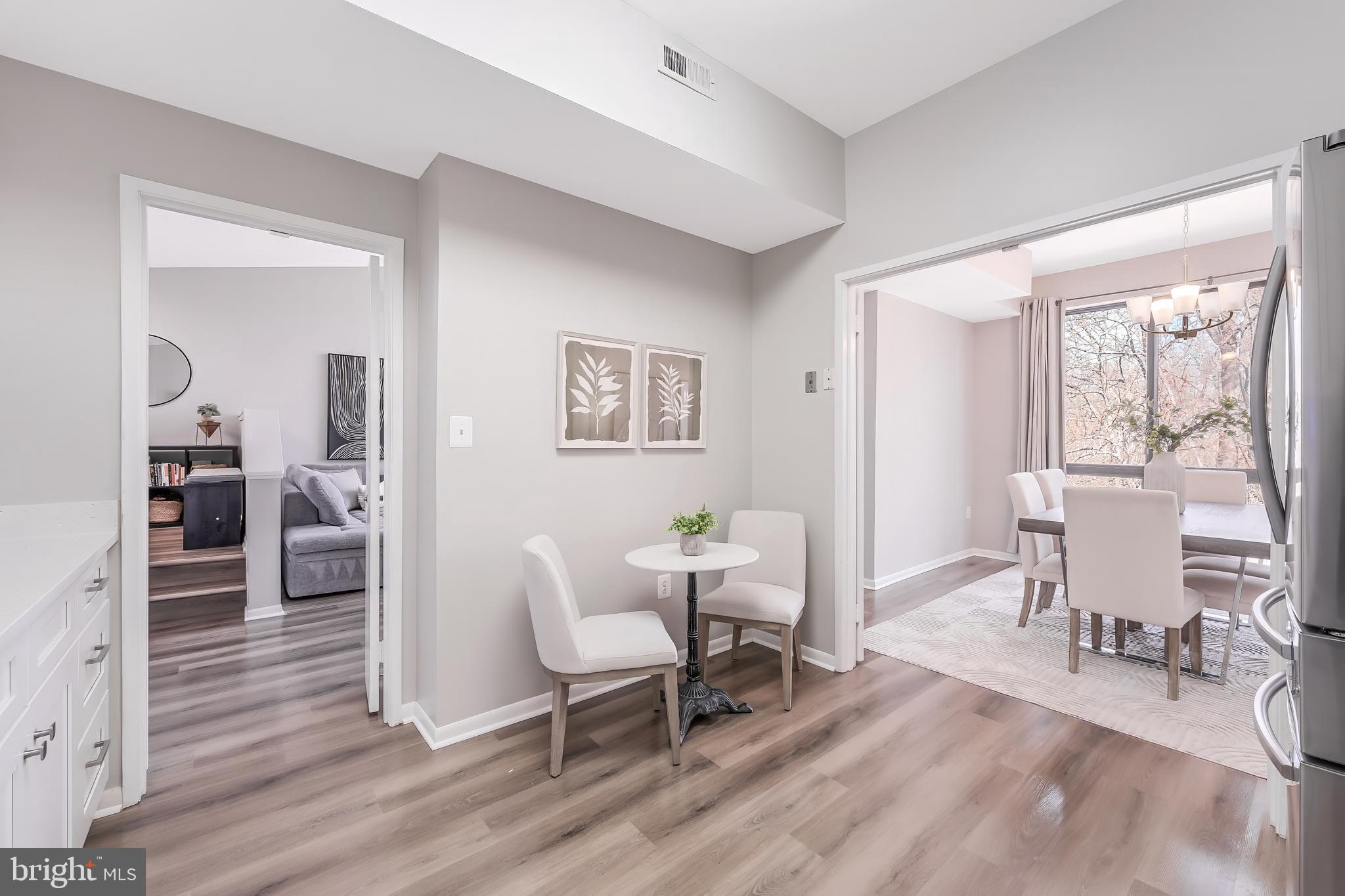 11564 Rolling Green Court, Unit 12/301B Reston, VA 20191 - Photo 5 of 31 a living room with furniture a dining table and a large window
