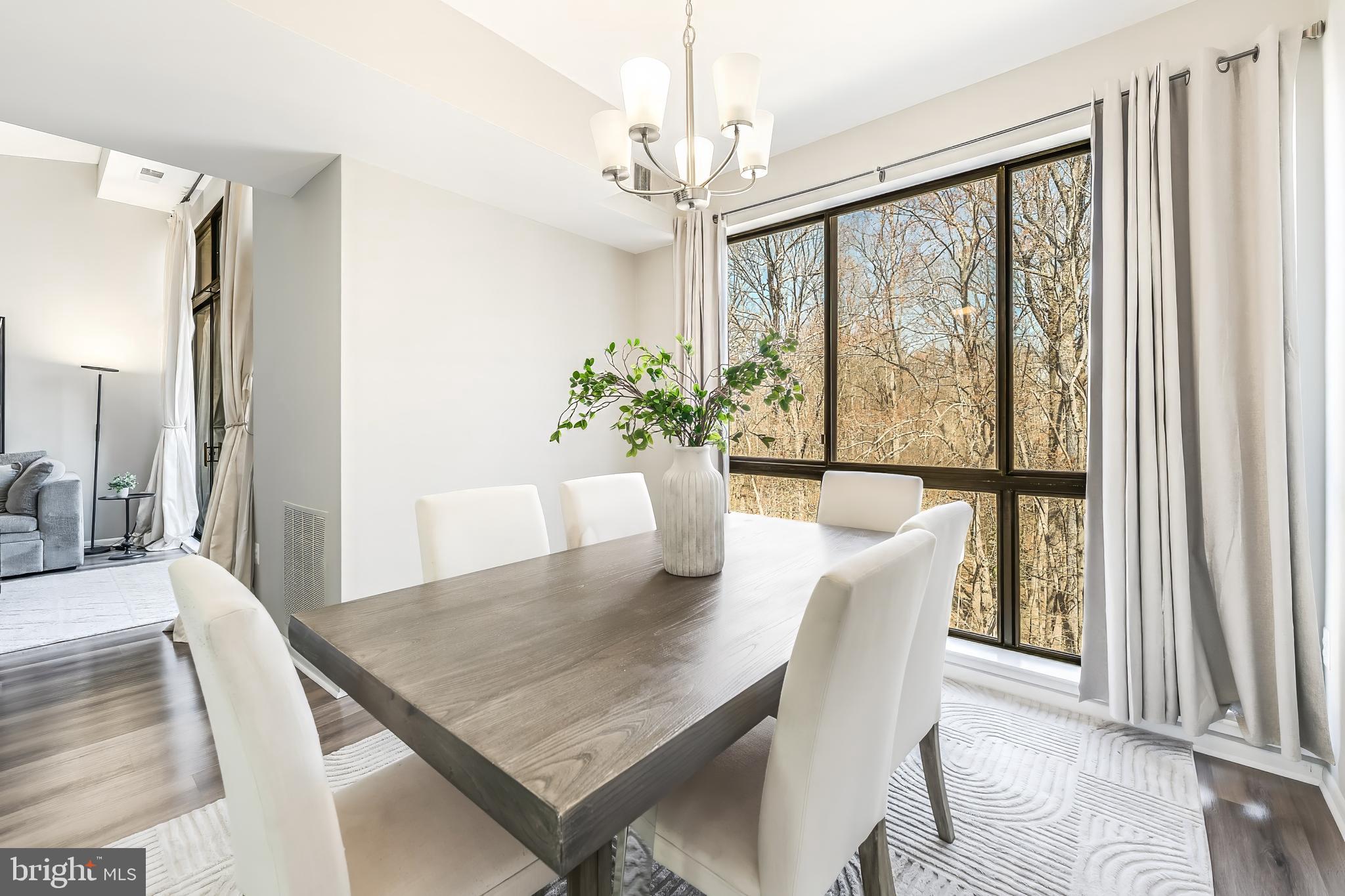11564 Rolling Green Court, Unit 12/301B Reston, VA 20191 - Photo 10 of 31 a view of a dining room with furniture window and wooden floor