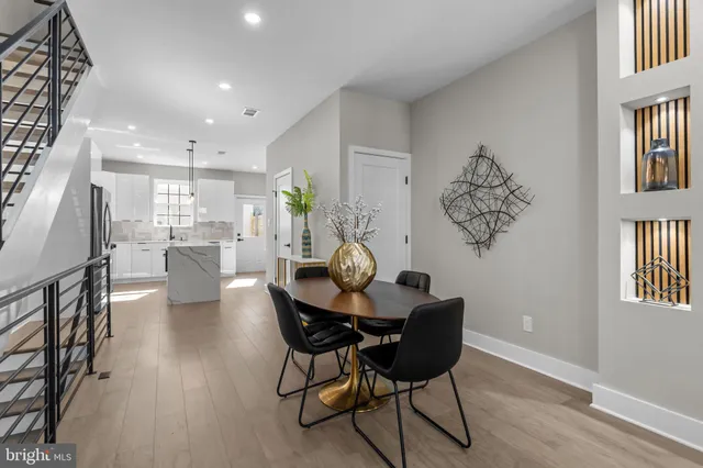 an entryway with wooden floor mirror and windows