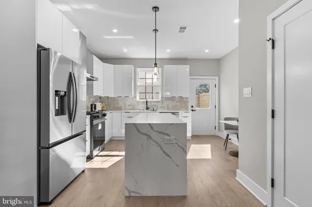 a large kitchen with a lot of counter space and a sink