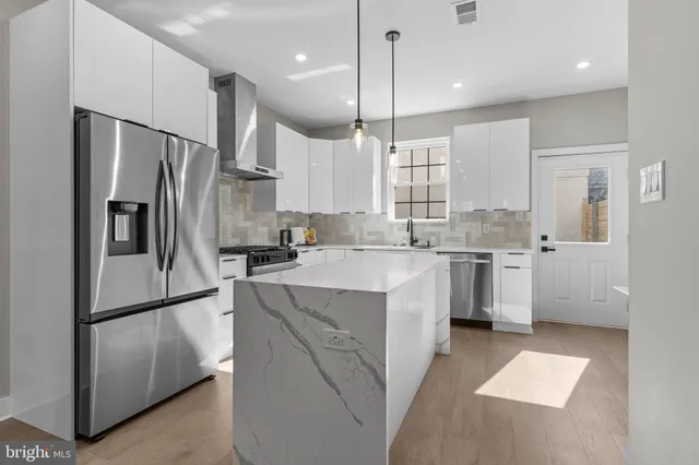 a kitchen with granite countertop a sink stove and cabinets