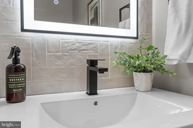 a kitchen with stainless steel appliances granite countertop a stove a sink and white cabinets