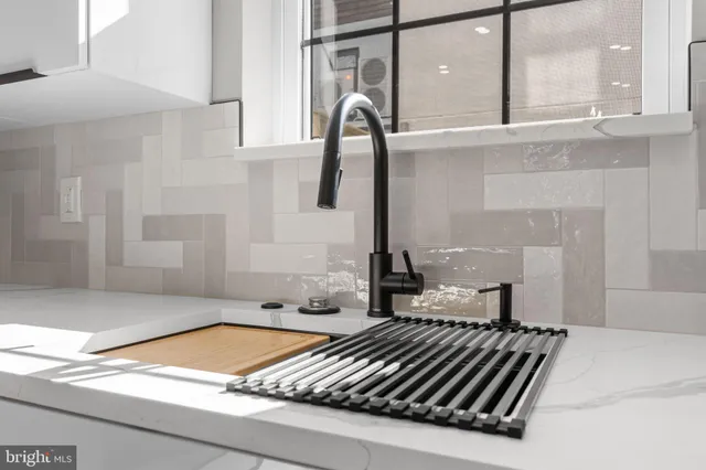 a view of empty room with wooden floor and windows