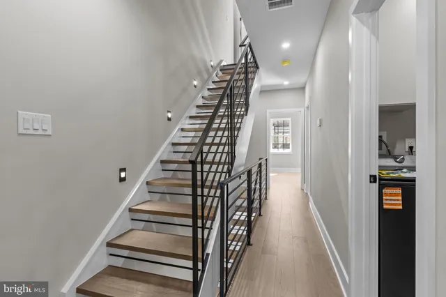 a view of entryway and gallery with wooden floor