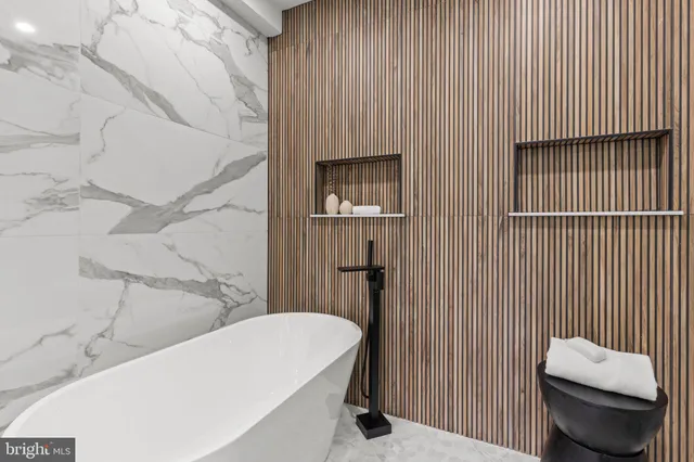 a view of an empty room with wooden floor and stairs
