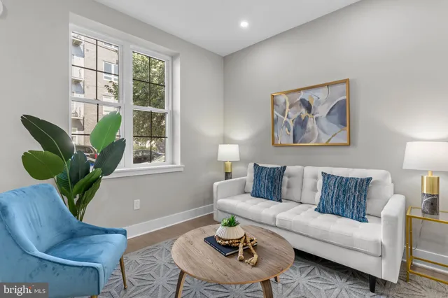 a living room with furniture and a lamp