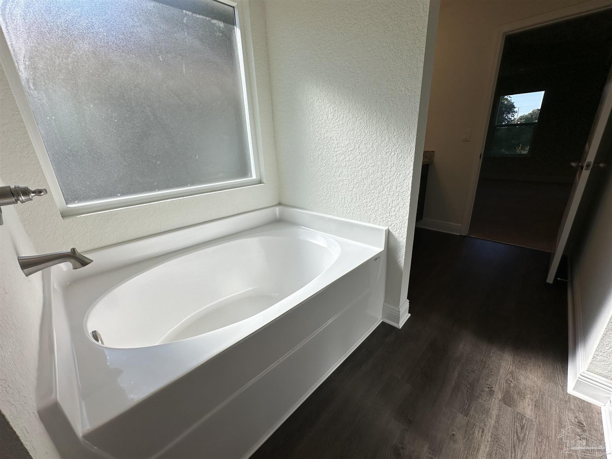 5451 Cherub Circle Milton, FL 32583 - Photo 11 of 13 a bathroom with a bathtub