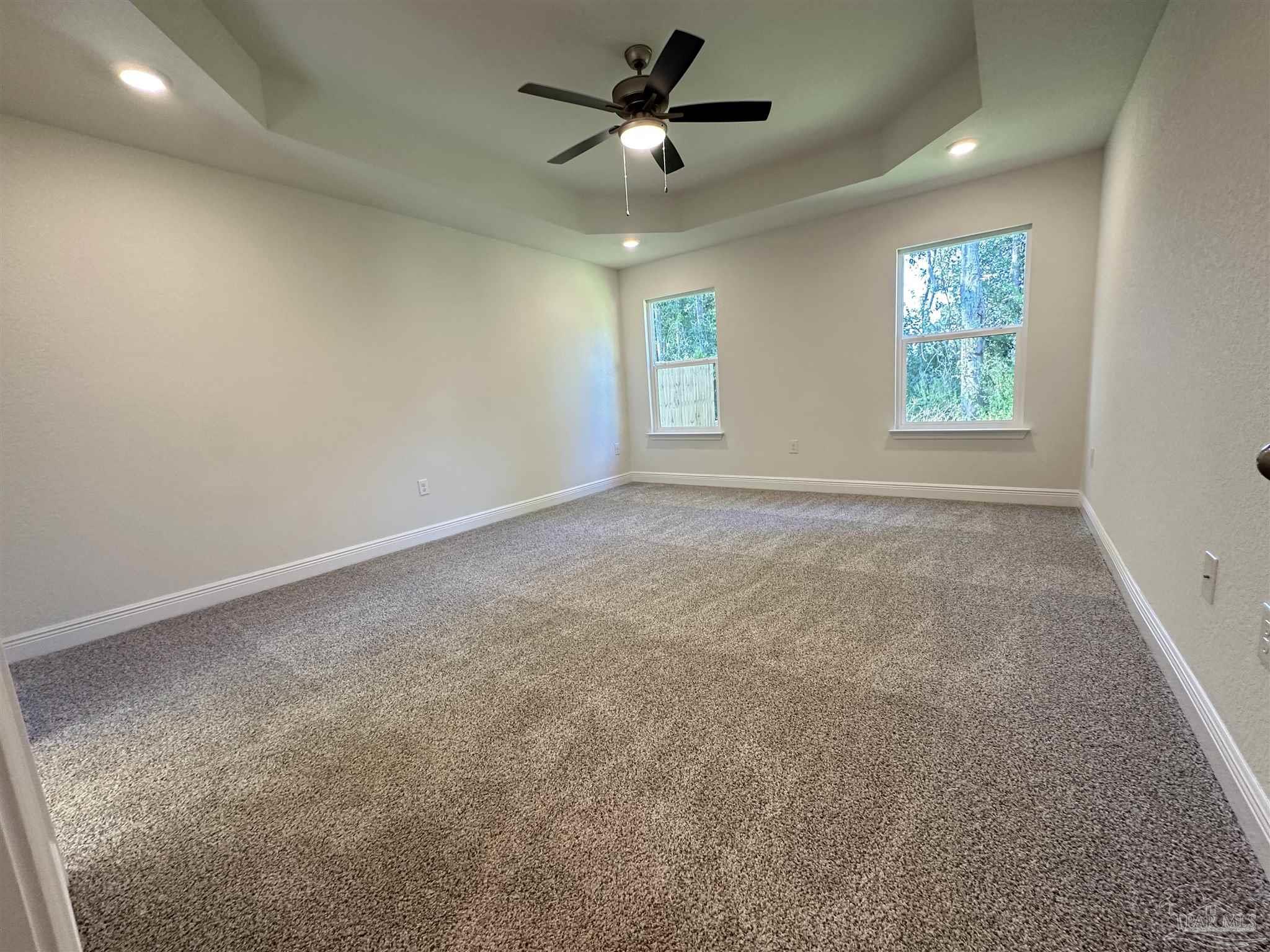5451 Cherub Circle Milton, FL 32583 - Photo 9 of 13 an empty room with windows and fan