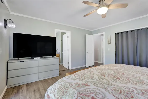 a bedroom with a bed and a flat screen tv