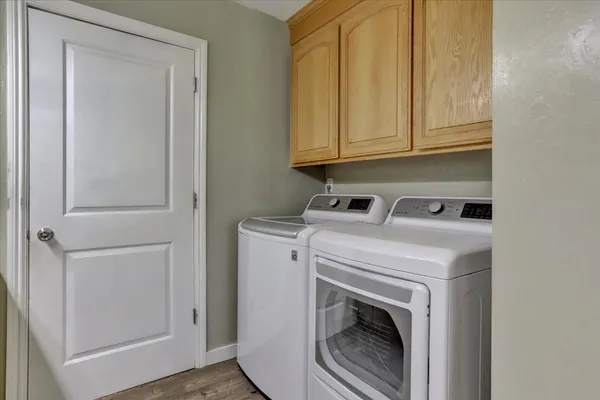 a kitchen with stainless steel appliances granite countertop a sink cabinets and wooden floor