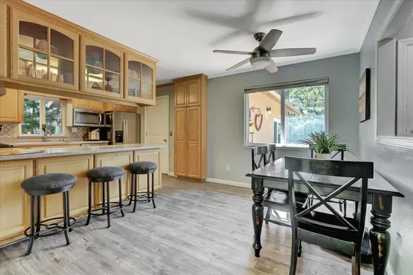 a kitchen with stainless steel appliances granite countertop a refrigerator and a sink