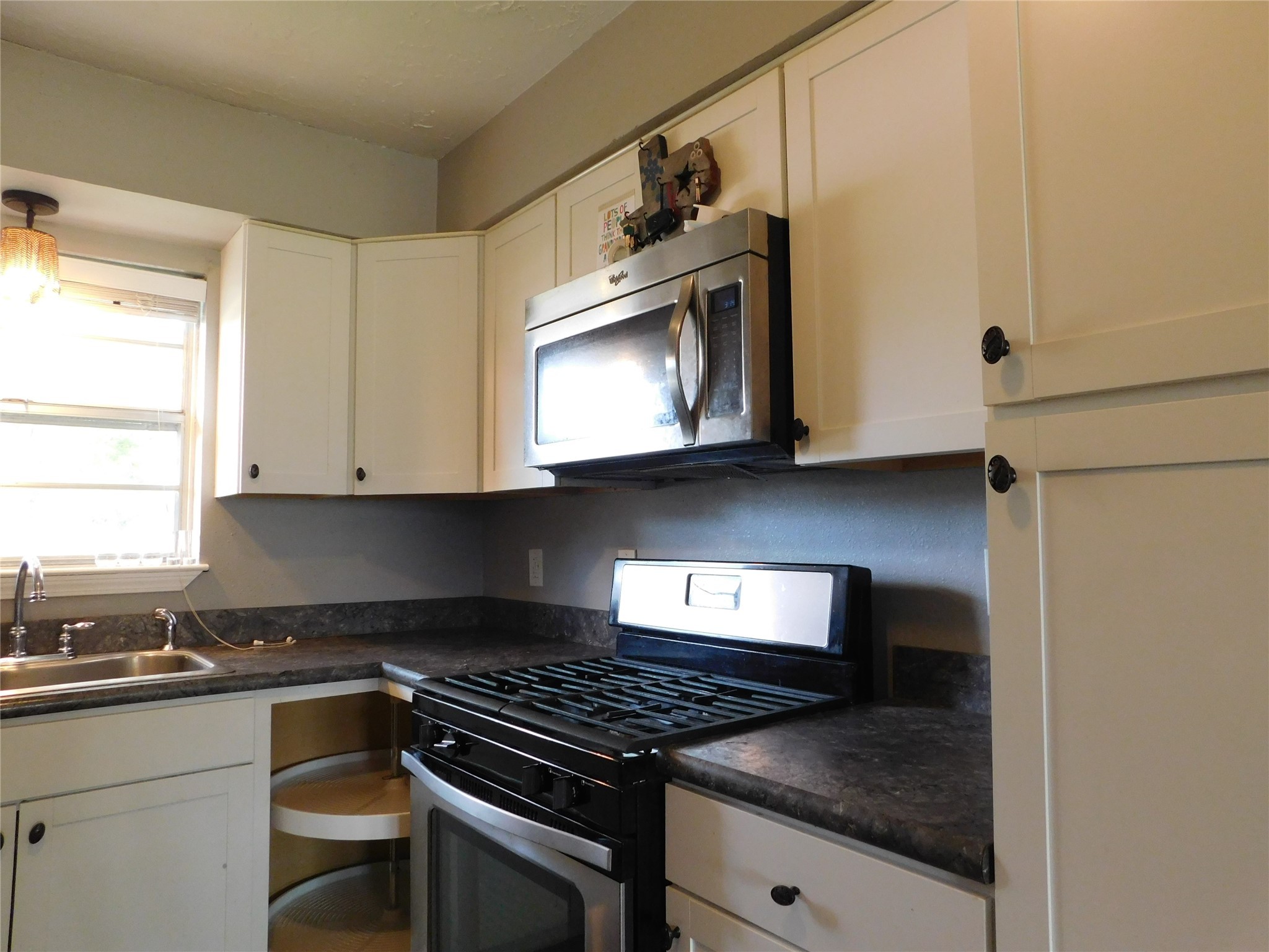 5003 Apple Springs Drive Pearland, TX 77584 - Photo 21 of 29 a kitchen with stainless steel appliances granite countertop a stove and a microwave