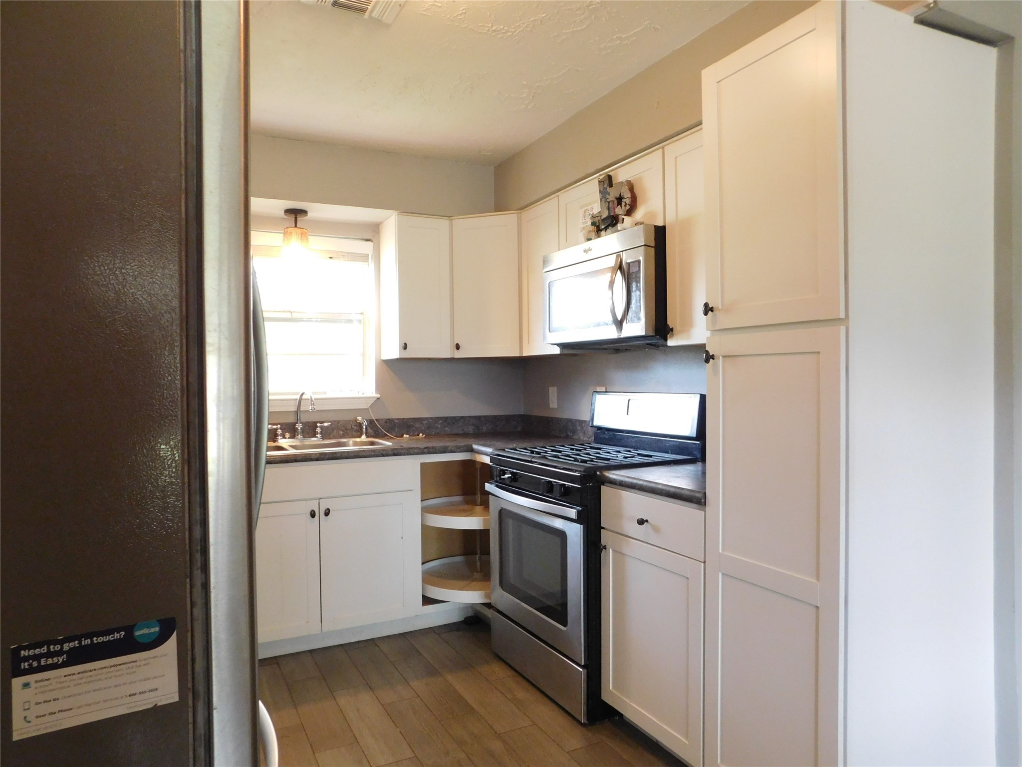 5003 Apple Springs Drive Pearland, TX 77584 - Photo 22 of 29 a kitchen with stainless steel appliances granite countertop white cabinets and a stove top oven