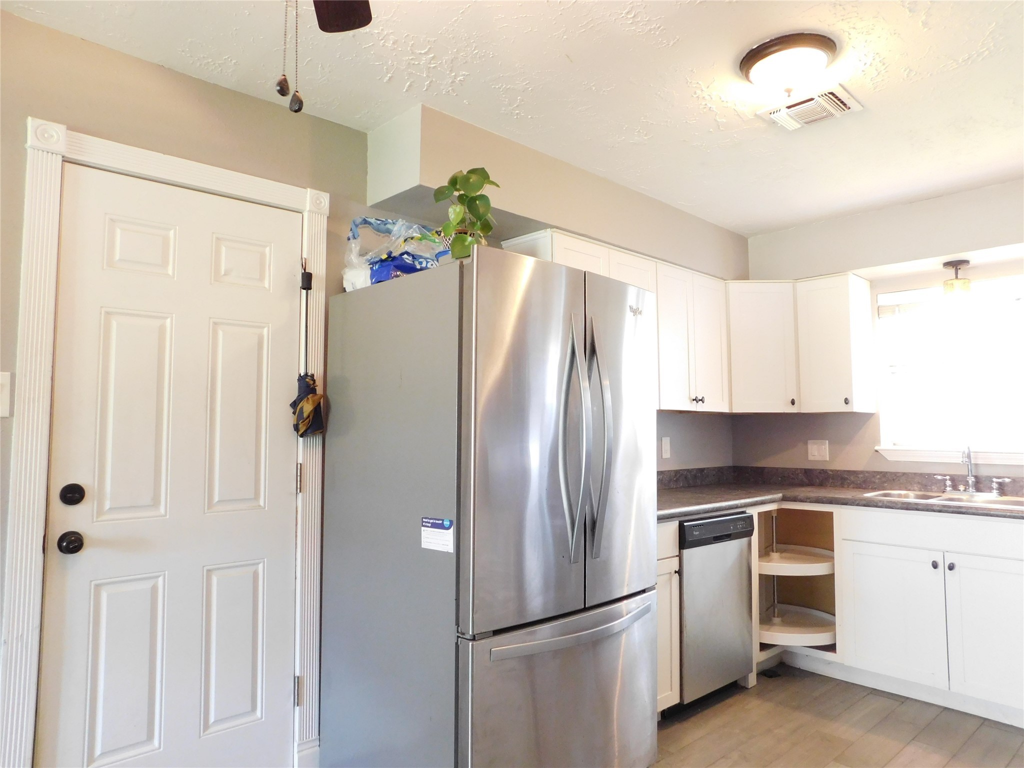 5003 Apple Springs Drive Pearland, TX 77584 - Photo 24 of 29 a kitchen with stainless steel appliances a refrigerator sink and cabinets