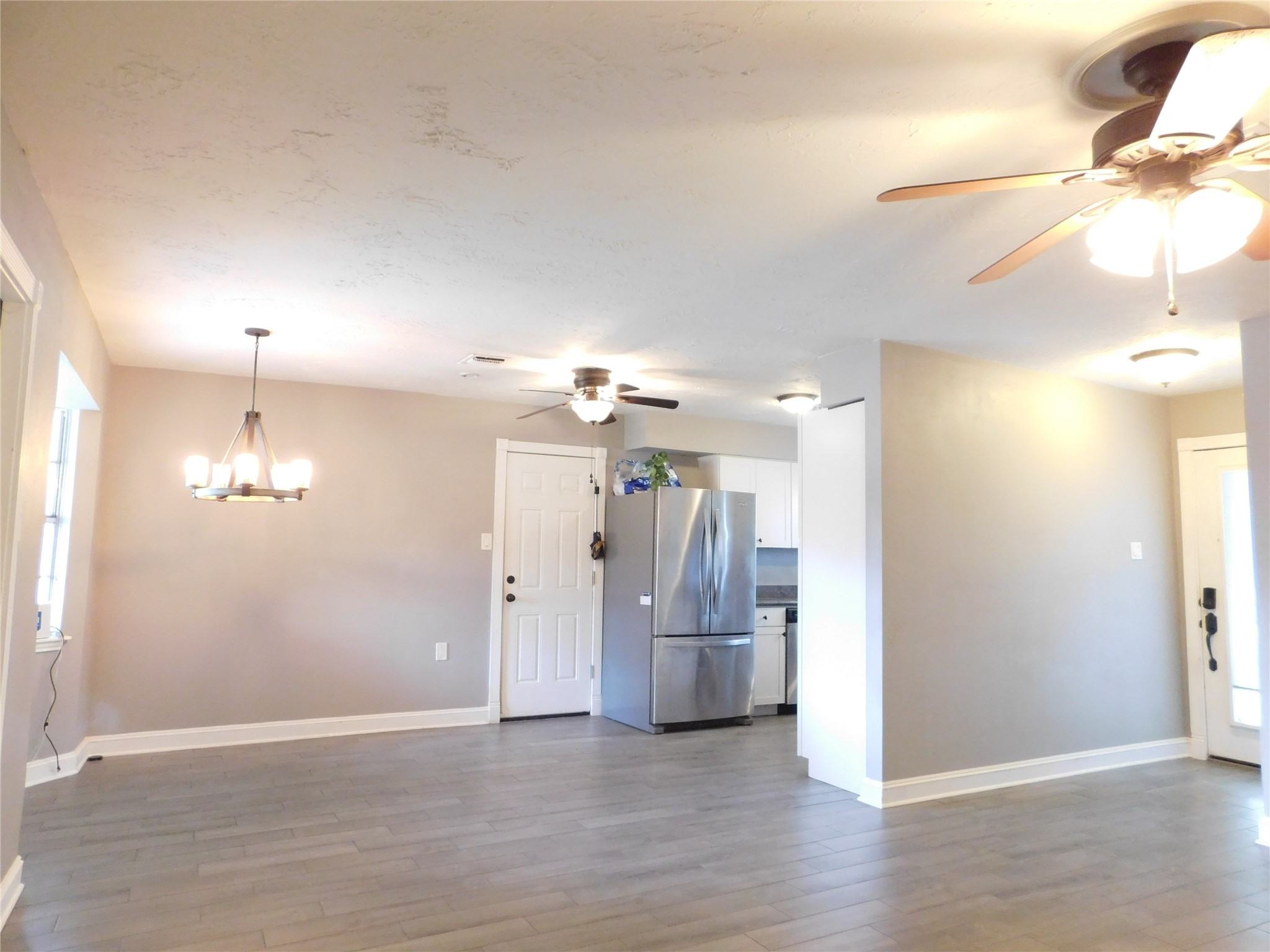 5003 Apple Springs Drive Pearland, TX 77584 - Photo 4 of 29 a view of a room with a chandelier fan and kitchen view