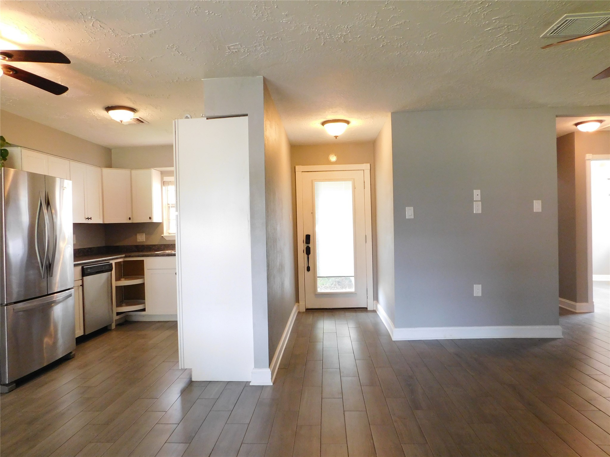 5003 Apple Springs Drive Pearland, TX 77584 - Photo 7 of 29 a view of a kitchen with a refrigerator a stove top oven a refrigerator and wooden floor