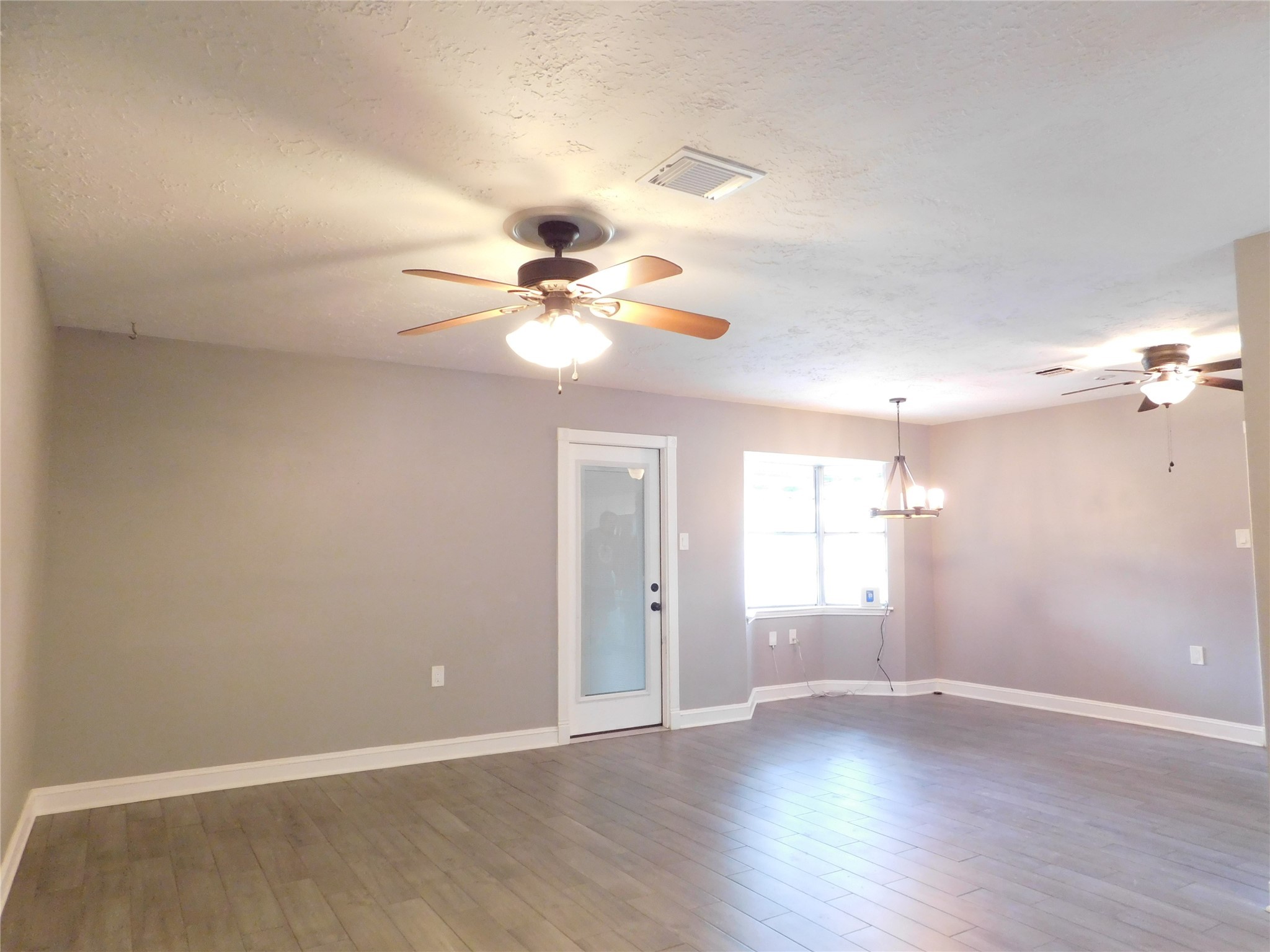5003 Apple Springs Drive Pearland, TX 77584 - Photo 8 of 29 wooden floor in an empty room with a window