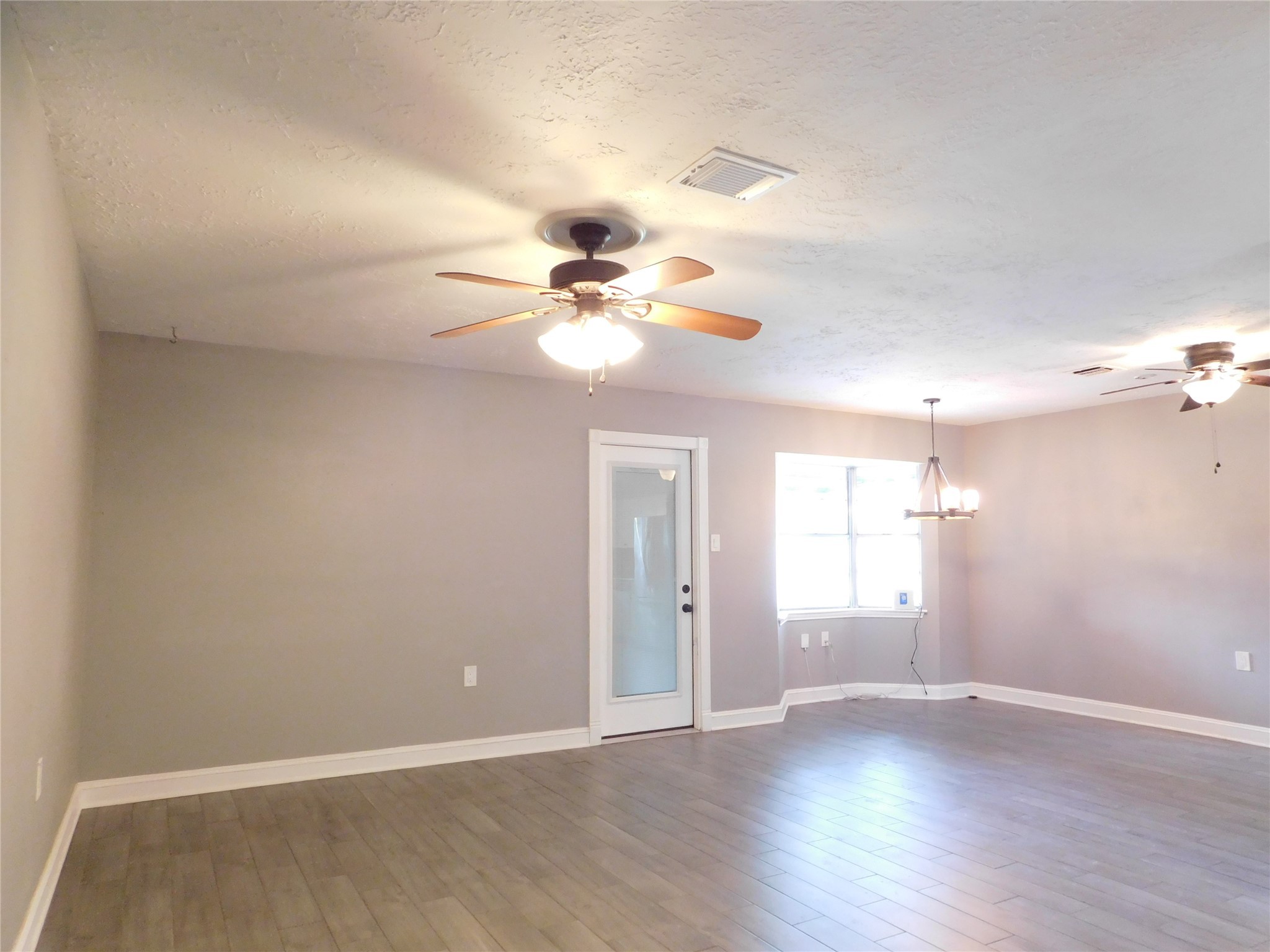 5003 Apple Springs Drive Pearland, TX 77584 - Photo 9 of 29 wooden floor in an empty room with a window