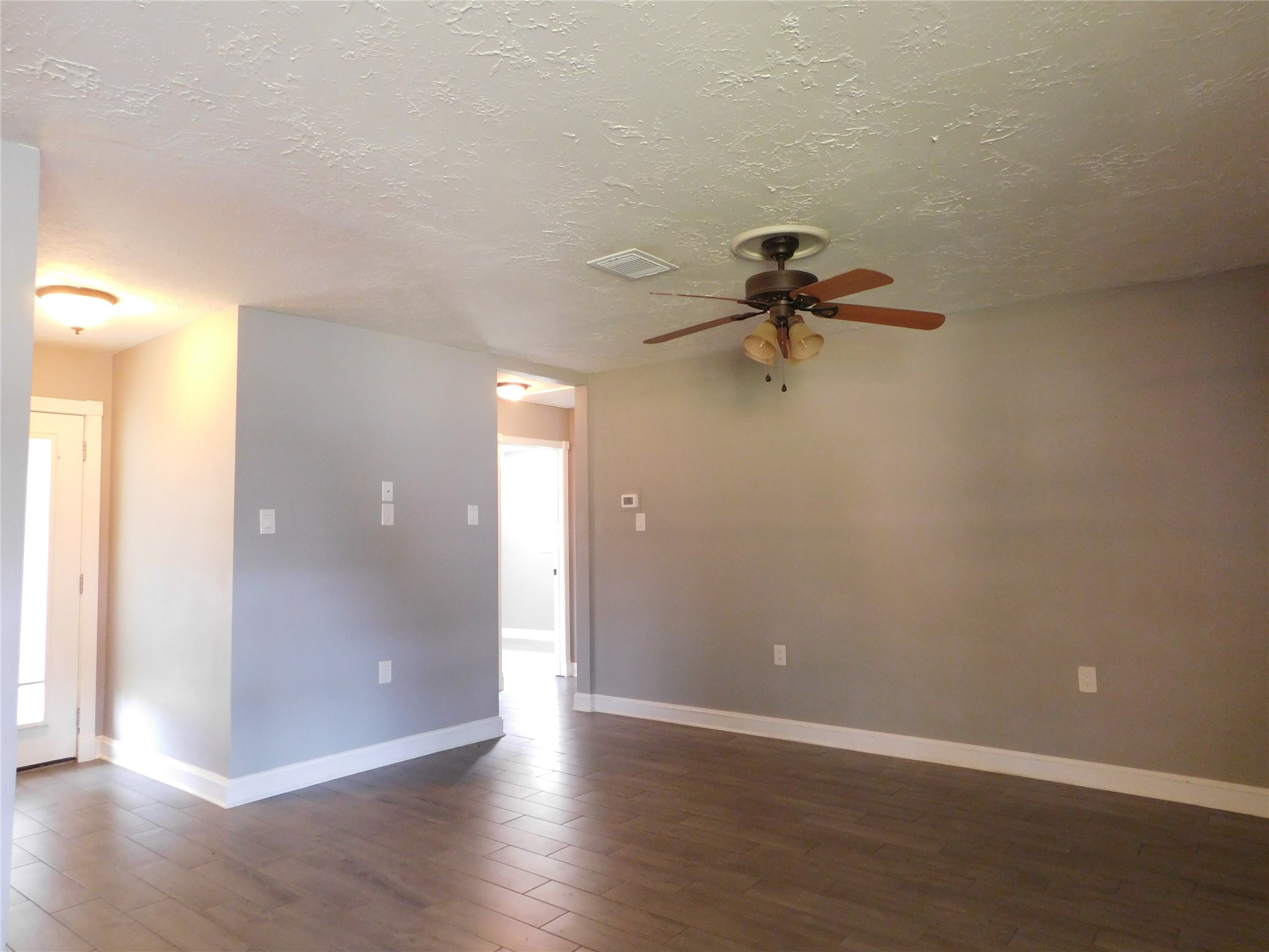 5003 Apple Springs Drive Pearland, TX 77584 - Photo 10 of 29 a view of a room with wooden floor and a ceiling fan