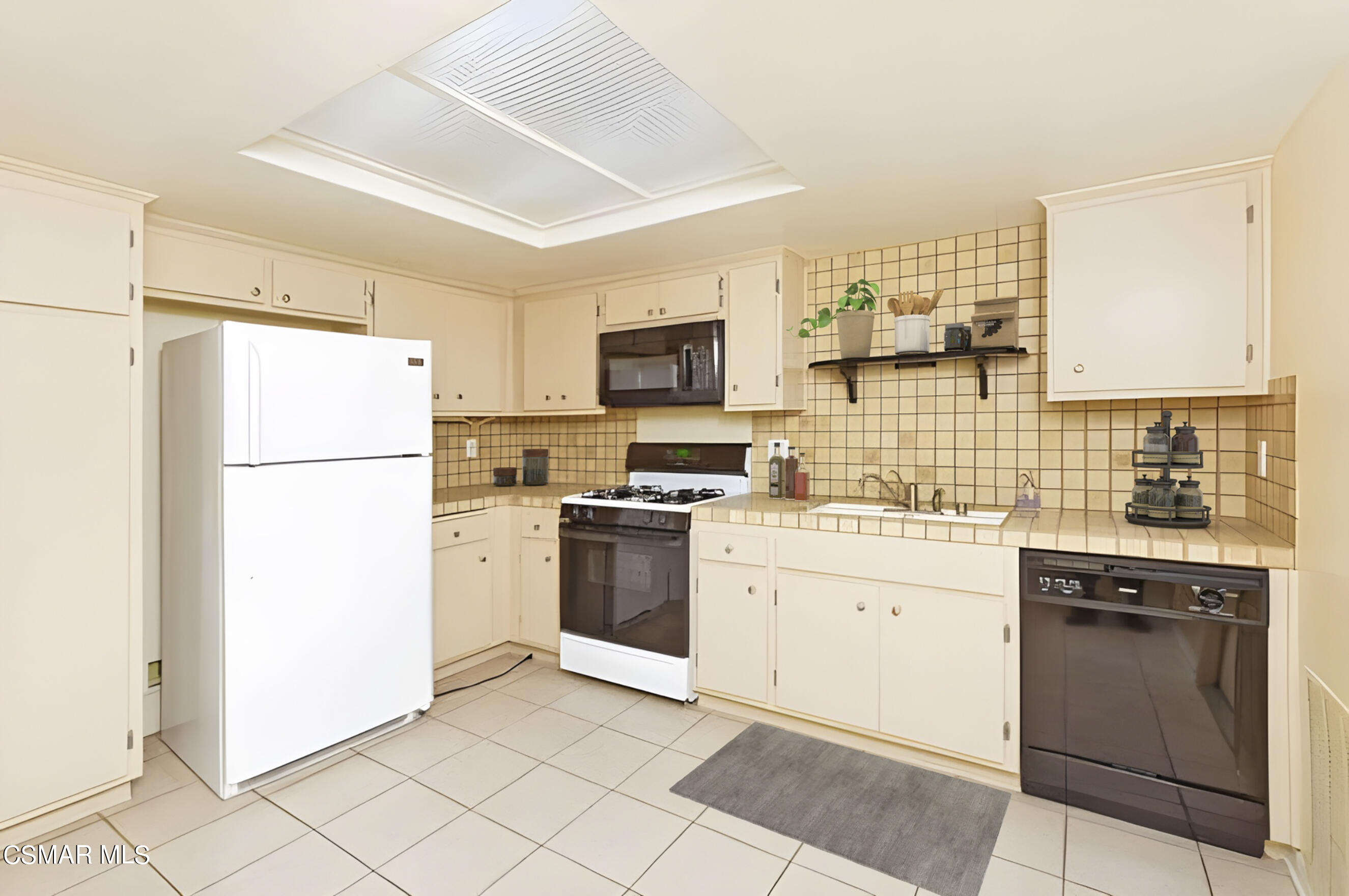 3345 Manorgate Place Simi Valley, CA 93065 - Photo 13 of 27 a kitchen with a refrigerator stove and sink