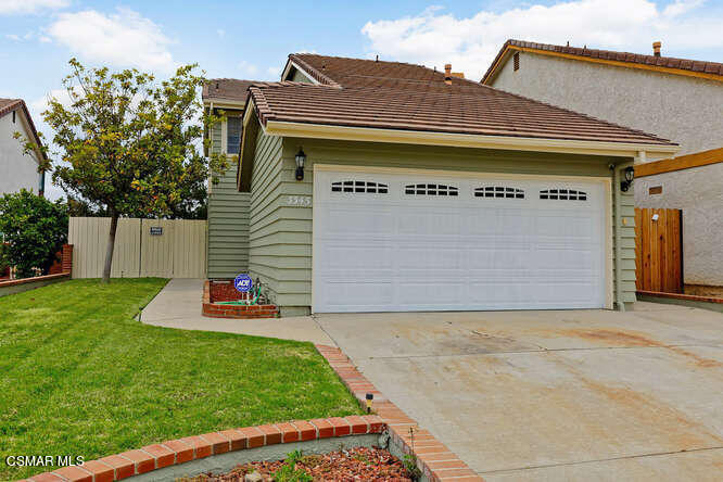 3345 Manorgate Place Simi Valley, CA 93065 - Photo 3 of 27 a front view of a house with a yard and garage
