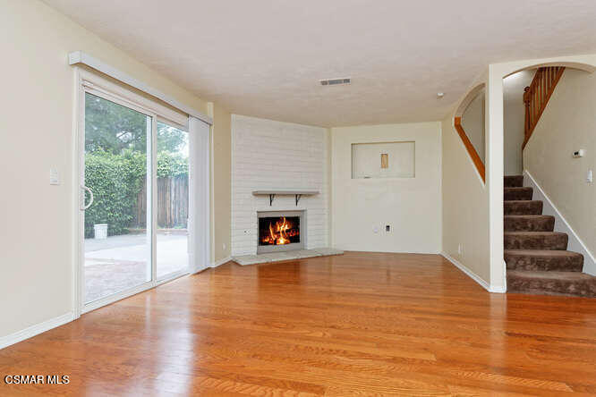 3345 Manorgate Place Simi Valley, CA 93065 - Photo 21 of 27 a view of empty room with wooden floor and fireplace