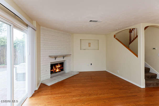 3345 Manorgate Place Simi Valley, CA 93065 - Photo 22 of 27 a view of empty room with wooden floor and fireplace