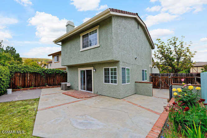 3345 Manorgate Place Simi Valley, CA 93065 - Photo 24 of 27 a front view of a house with a yard and potted plants