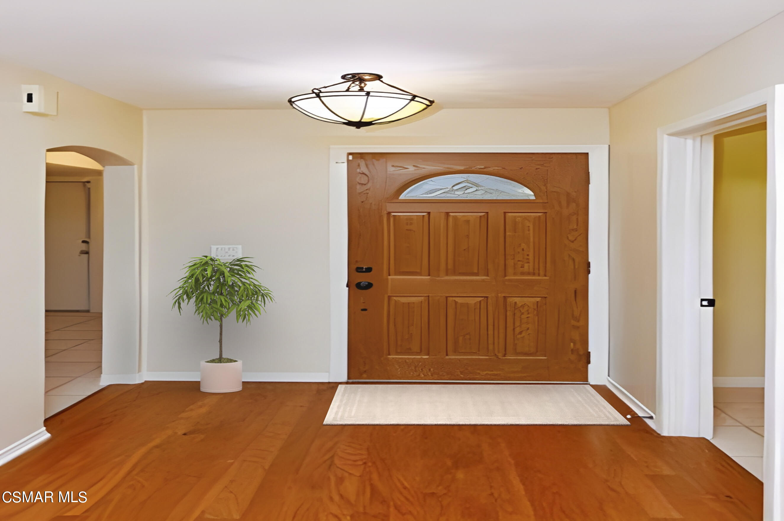 3345 Manorgate Place Simi Valley, CA 93065 - Photo 4 of 27 a view of a hallway with wooden floor and a chandelier